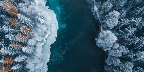 Aerial view of the edge between blue lake or sea and snow forest landscape background banner, banner