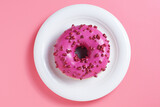 Pink donut in plate