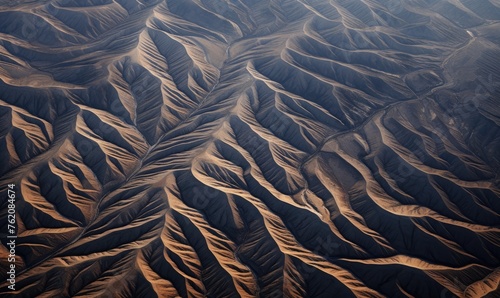 Aerial view revealing patterns of mountain ridges and valleys
