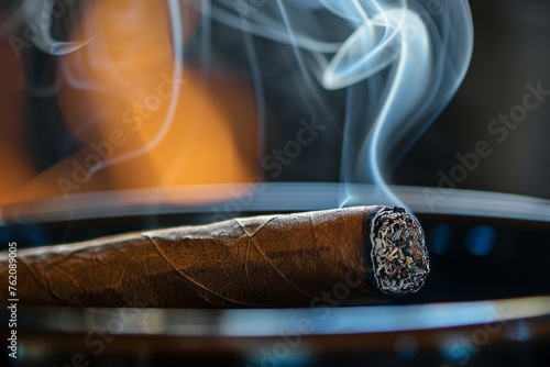 Cigar in a wooden bowl with smoke on a dark background © Dina