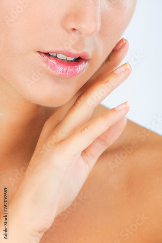 Face, lips and hand with woman touching skin for dermatology, beauty and moisturizer isolated on white background. Facial, balm for mouth with shine and cosmetic care, wellness and skincare in studio