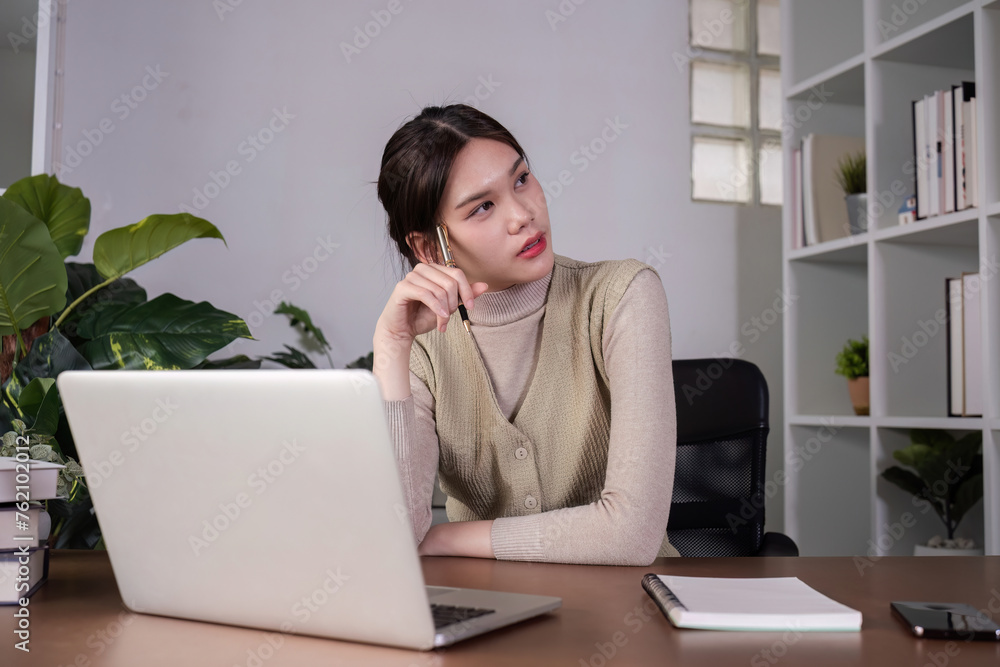 Asian female student studying online Video calls through Zoom about business administration and accounting subjects attentively Asian female student studying online Video calls through Zoom about business administration and accounting subjects attentively