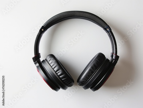 Top-down view of modern headphones with sleek black design, isolated on a white background, hinting at technology, music, and leisure.