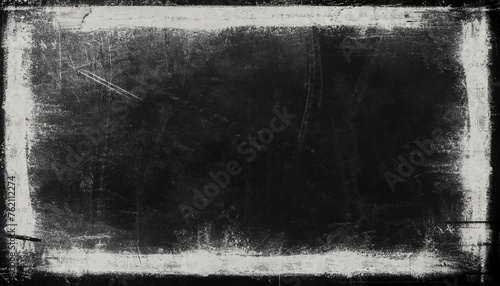 Black grunge scratched scary background with frame, distressed chalkboard, old film effect, copy space for design; abstract texture; horizontal