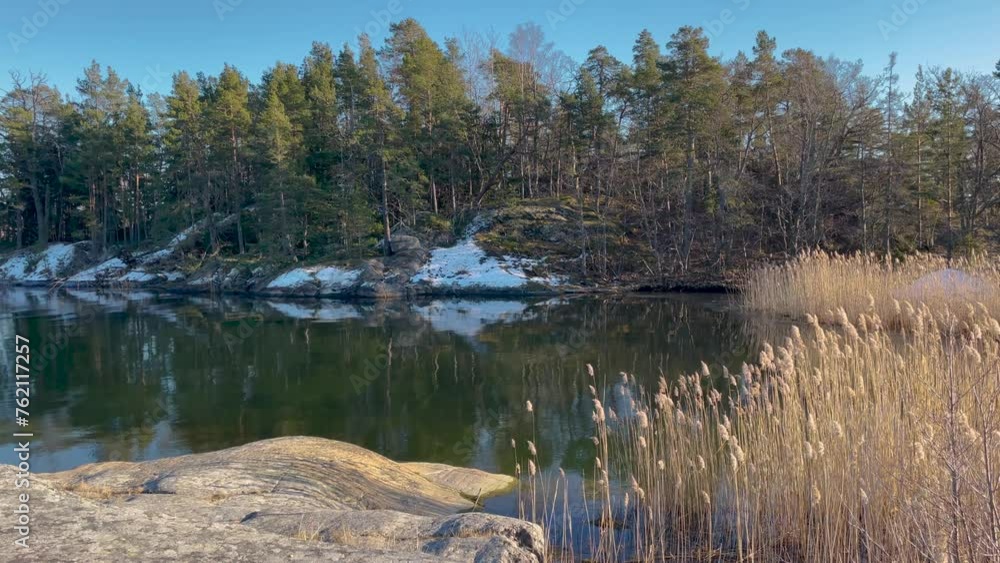 Quiet winter day on Stockholm Archipelago island with snow patches and calm water Quiet winter day on Stockholm Archipelago island with snow patches and calm water