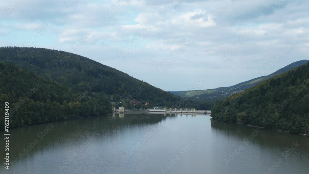 Reflective Międzybrodzkie Lake and its dam, surrounded by the dense forests of the Beskidy Mountains in Poland. Reflective Międzybrodzkie Lake and its dam, surrounded by the dense forests of the Beskidy Mountains in Poland.