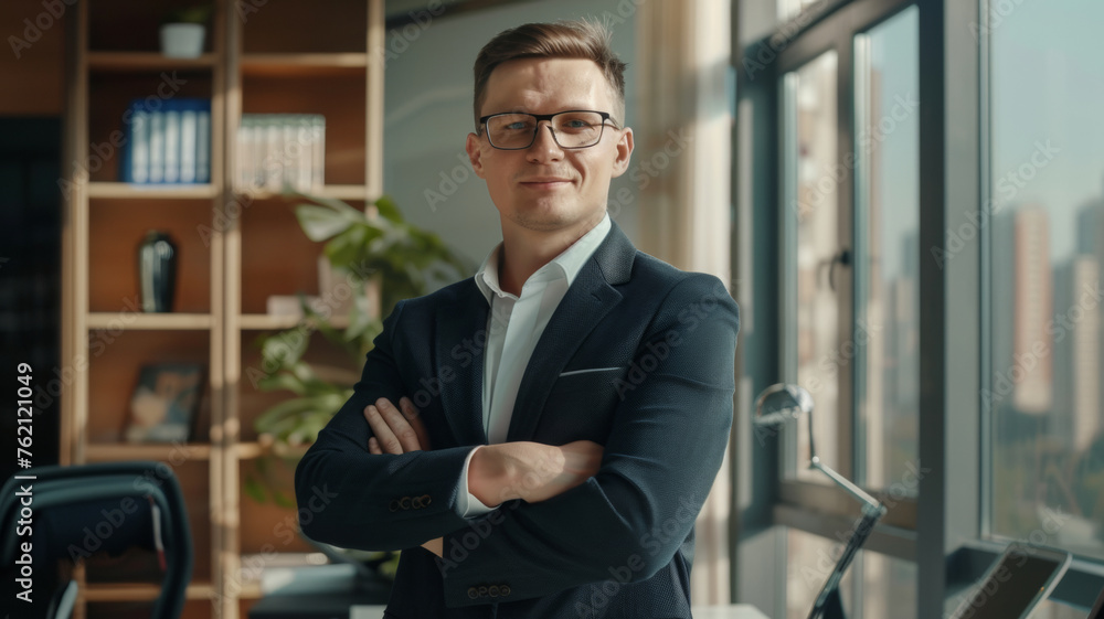 Confident businessman in a modern office with arms crossed. Confident businessman in a modern office with arms crossed.