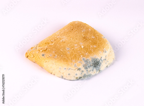 Moldy bread on a white background. Close-up.