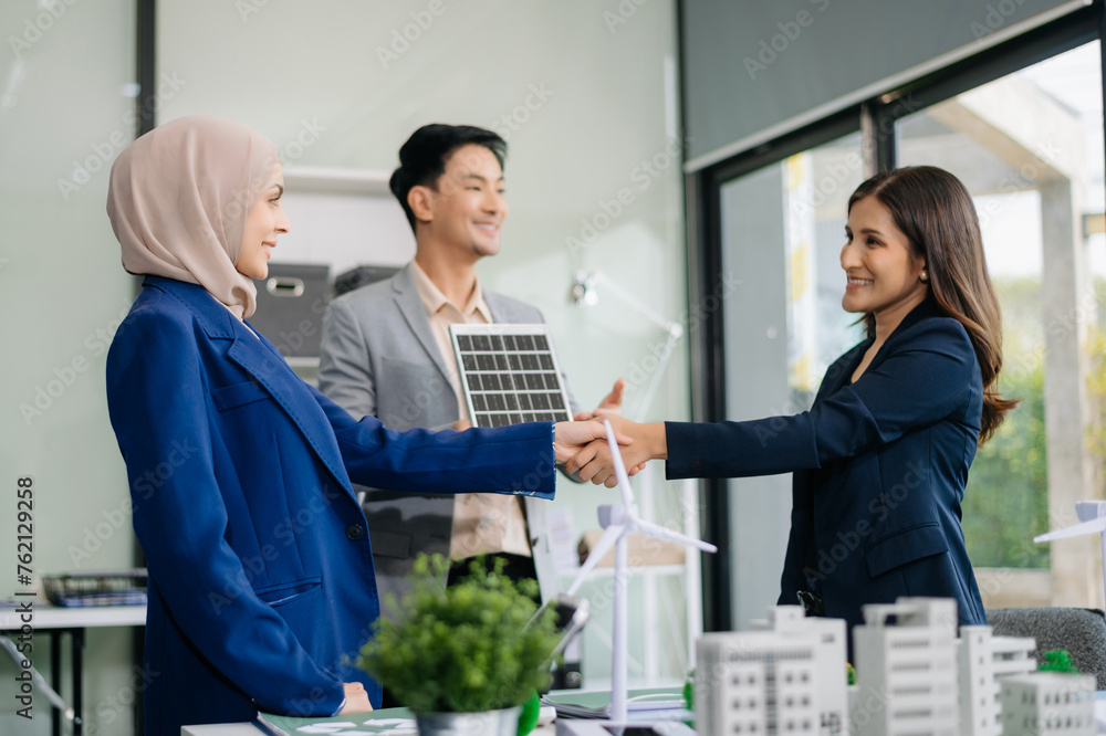 .Business people having consultation about wind energy at company office. Business team discussing about windmill and alternative green enery. Net zero and carbon neutral concept