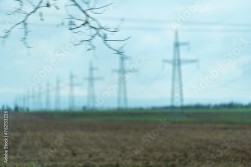 High voltage towers with sky background. Power line support with wires for electricity transmission. High voltage grid tower with wire cable at distribution station. Energy industry, energy saving