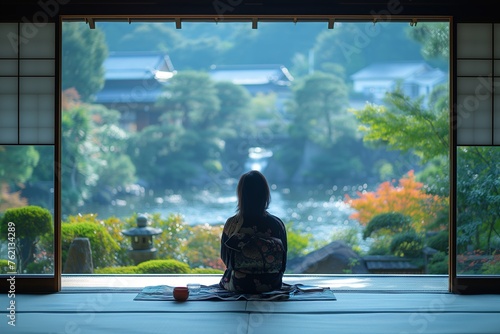 Seated serenely, a woman gazes out at a tranquil Japanese garden from the traditional sliding doors of a house