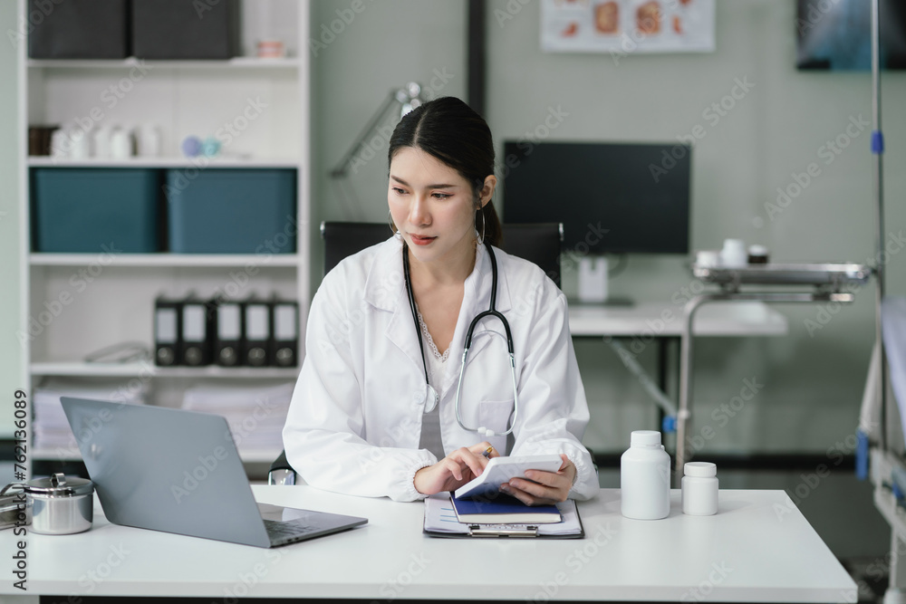 Doctor working in hospital use calculator, Healthcare and medical concept. Doctor working in hospital use calculator, Healthcare and medical concept.
