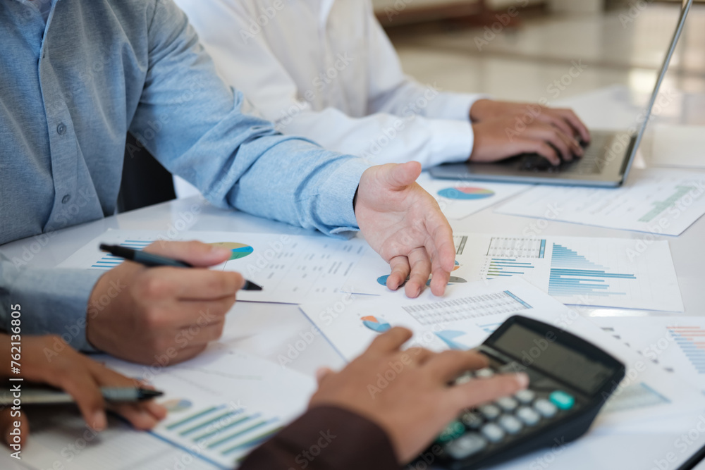 A team of business people is brainstorming to analyze investment project data. A team of business people is brainstorming to analyze investment project data.