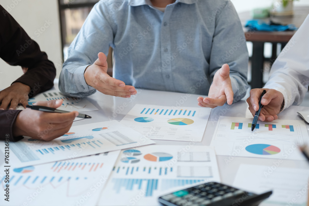 A team of business people is brainstorming to analyze investment project data. A team of business people is brainstorming to analyze investment project data.
