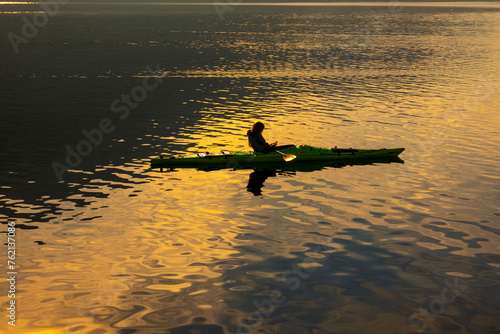 Wallpaper Mural Woman in a Kayak and Using Smartphone on Lake with Sunlight in Switzerland. Torontodigital.ca