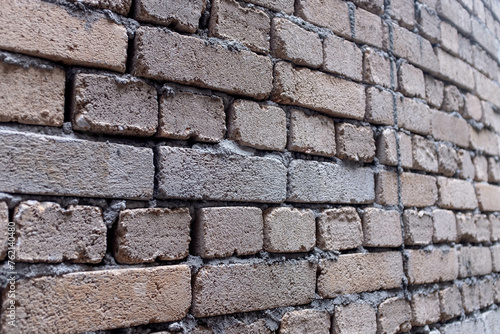 Shoddy brick work on a wall using clay bricks in Asia
