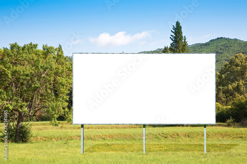 Quadro su tela Blank advertising signboard in a countryside with trees - Rural scene concept wi