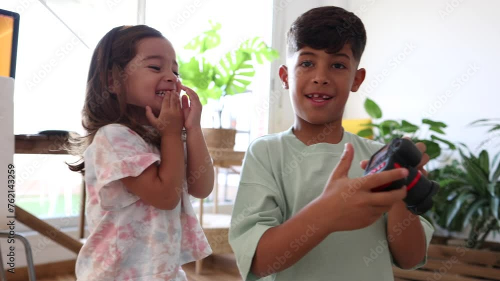 Siblings' Joy: Sharing a Camera for a Fun Snapshot - Sibling fun with a ...