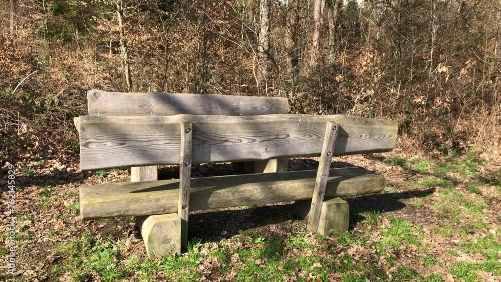 Wooden park bench near a forest in the rural countryside Wooden park bench near a forest in the rural countryside