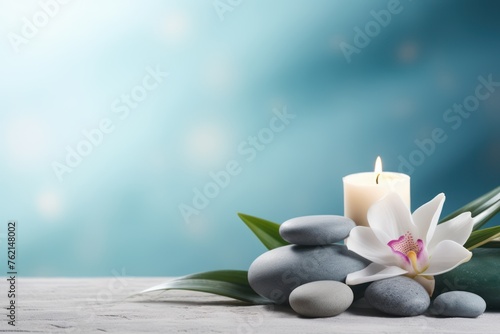 Spa composition. Pebbles, flower, candle, green leaf. Copy space
