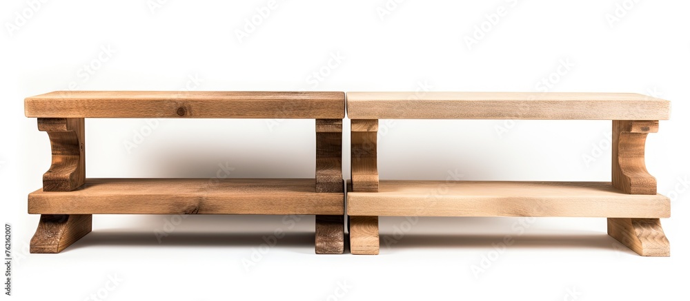 Two hardwood benches are placed side by side on a clean white surface. The contrast of the wood against the background creates a simple yet elegant look Two hardwood benches are placed side by side on a clean white surface. The contrast of the wood against the background creates a simple yet elegant look