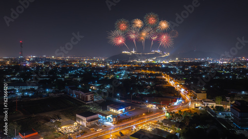 Firework over the mountain in the festival (Phra Nakhon Khiri) and city lights at night scene Phetchaburi province. Thailand.