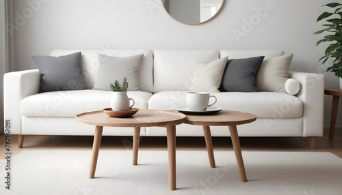 Round-wood-coffee-table-against-white-sofa--Scandinavian-home-interior-design-of-modern-living-room