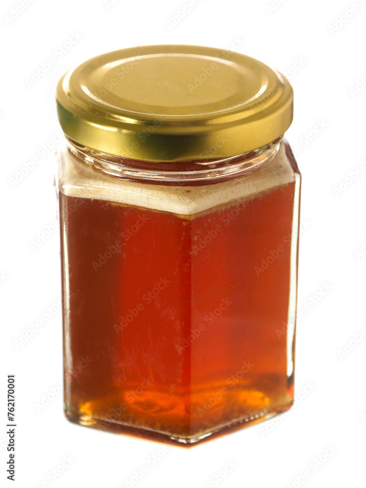 Glass bottle of fine honey with golden lid on white background. Agriculture organic product famous for its sweet taste and health benefits and value. Glass bottle of fine honey with golden lid on white background. Agriculture organic product famous for its sweet taste and health benefits and value.