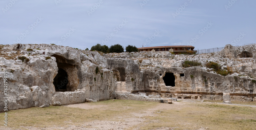 Rupestrian settlements (caves) in the Neapolis Archaeological Park in Syracuse, Sicily Italy - obrazy, fototapety, plakaty 