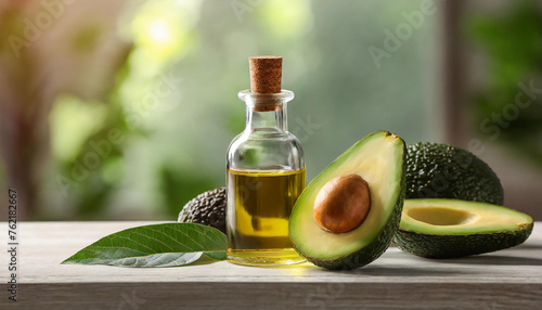 Close-up of small glass bottle of avocado essential oil and fresh avocado on table. Organic product