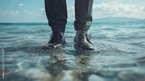 A businessman's symbolic act of removing his shoes to walk into the sea, representing the concept of work-life balance and the pursuit of simplicity and relaxation