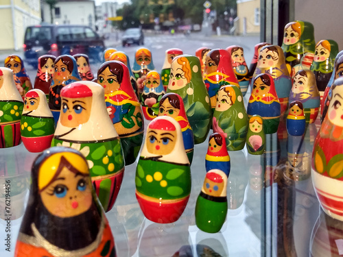 Handmade wooden russian dolls on a glass display case. photo