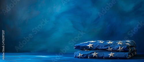 the photo shows the folded american flag on blue background photo