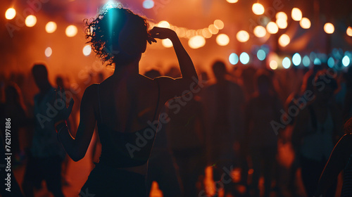 a solitary dancer lost in the rhythm of the music, at a music festival