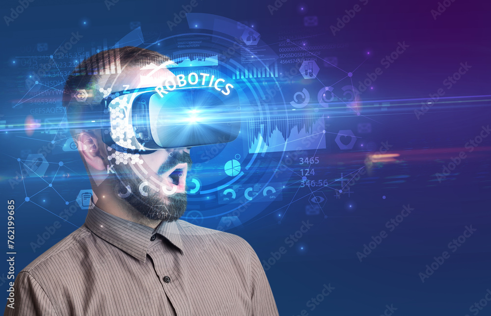 Businessman looking through VR glasses Businessman looking through VR glasses