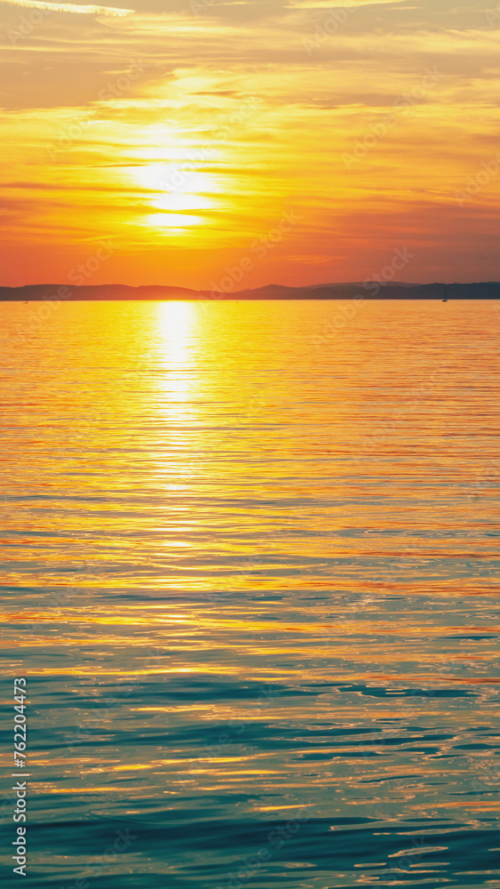 Seascape in the evening. Sunset over the sea. Dramatic sky. Natural landscape. Vertical banner