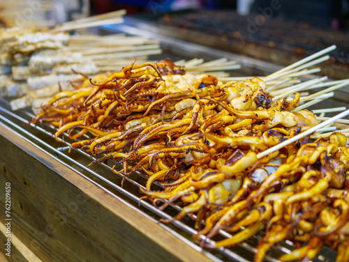 Grilled squid tentacles on skewers, street food