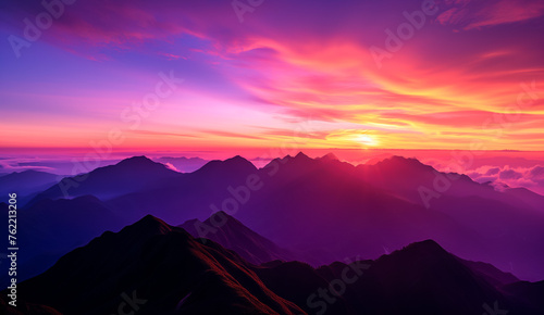 Majestic purple sunset over layered mountain silhouette