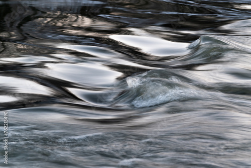 Turbulent water surface in wind, water waves close up, abstract landscape