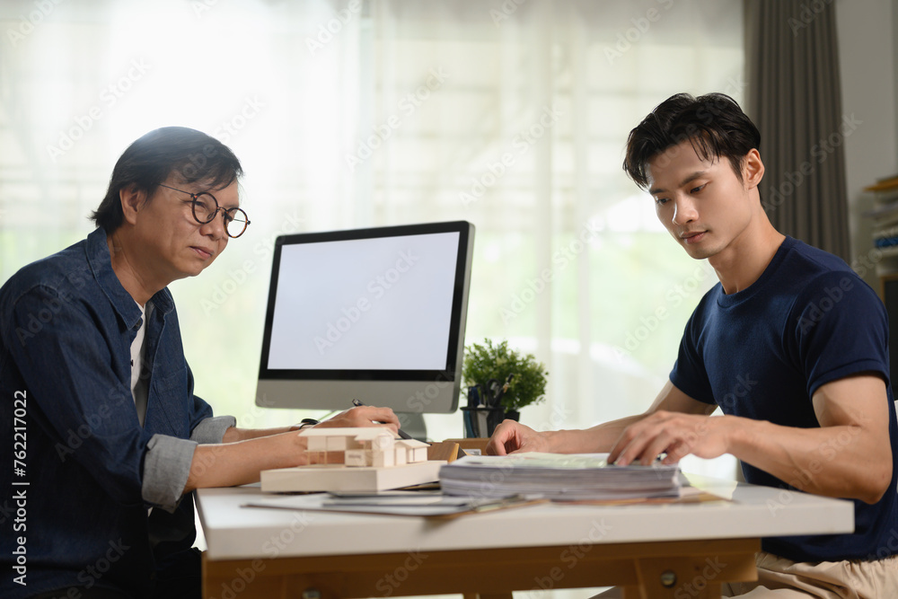 Millennial man discussing renovation project with professional interior designer Millennial man discussing renovation project with professional interior designer