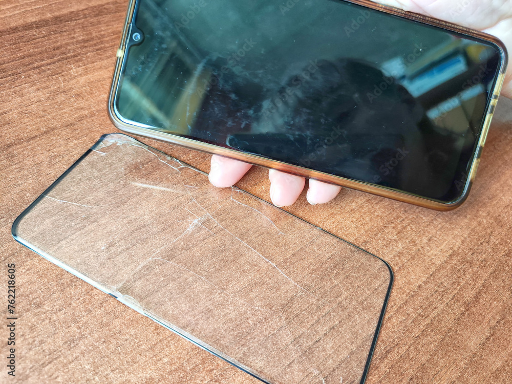 Removing Protective Film From a Cracked Screen. Peeling off a cracked