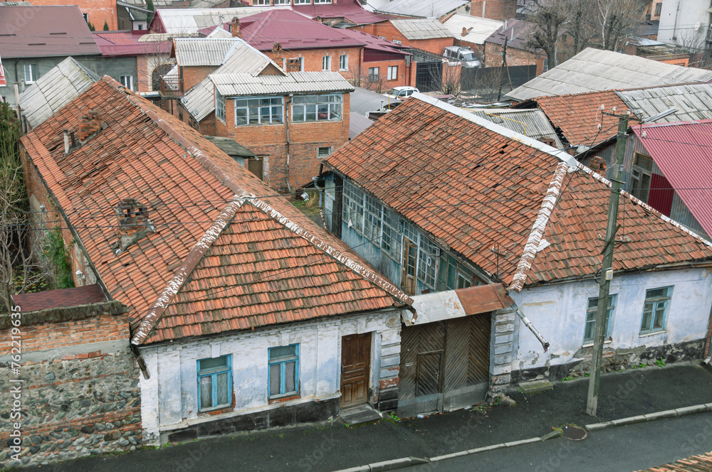 Top view of old houses with tiled roofs. House territory near old houses. The old district in the city of Vladikavkaz.