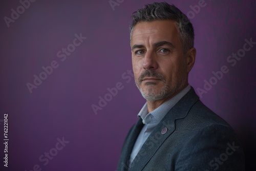 Confident detective in suit standing against a purple background