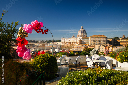 Terrace with Love balloons and tables. St Peter's Basilica on background