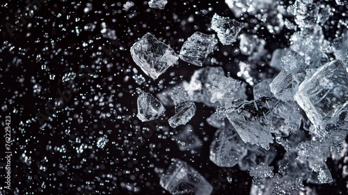 Crushed ice scattered across a dark background, depicting the motion of ice pieces dispersing