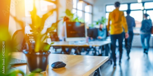 Modern startup office bustling with activity, highlighted by warm sunlight and vibrant plant life.