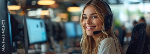 Happy customer service representative working in call center with headset and computer screen, smiling woman assisting customers