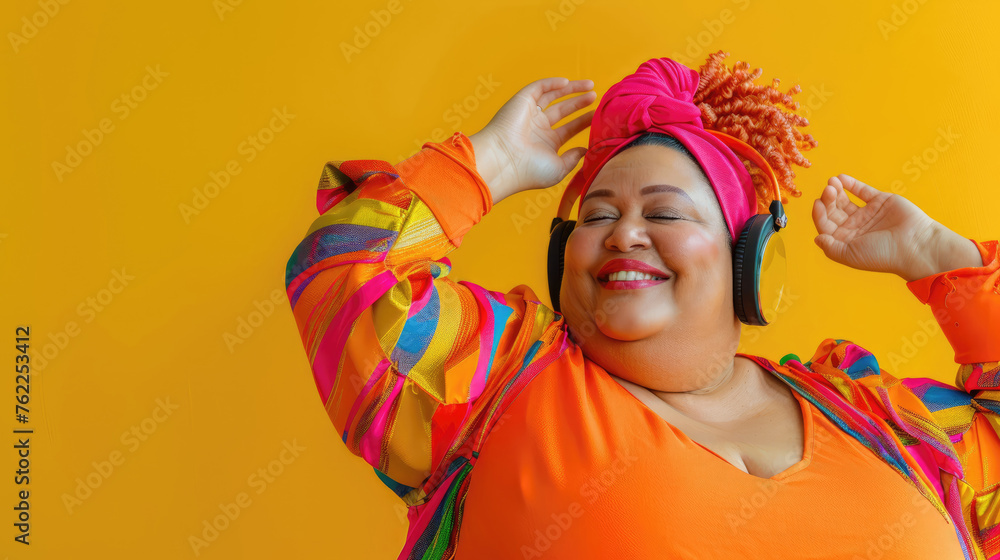 Happy eccentric fat woman in headphones listens to music with close eyes and dancing pleasure joy body positivity