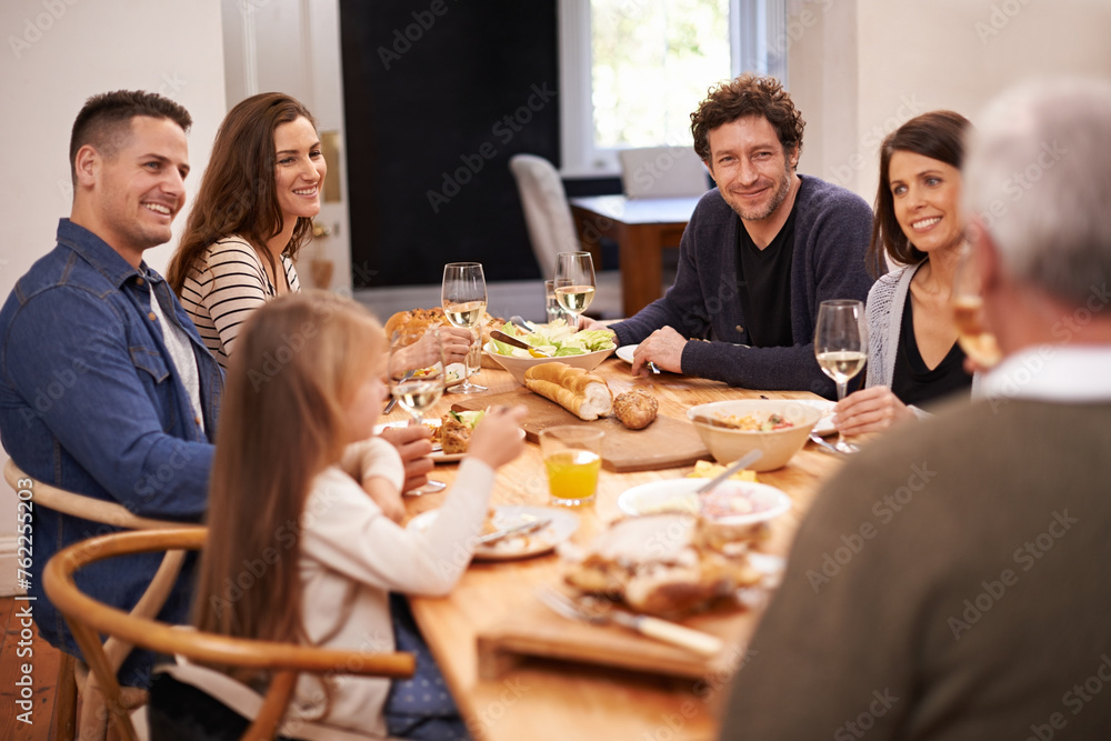 Smile, conversation and family at dinner in dining room for party, celebration or event at modern home. Happy, bonding and people enjoying meal, supper or lunch together with wine for toast at house. Smile, conversation and family at dinner in dining room for party, celebration or event at modern home. Happy, bonding and people enjoying meal, supper or lunch together with wine for toast at house.