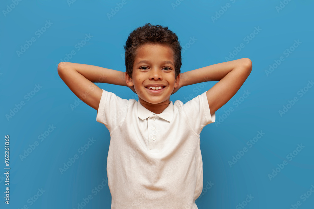 african american teenage boy in white polo resting and lying on blue isolated background, lazy child relaxing african american teenage boy in white polo resting and lying on blue isolated background, lazy child relaxing
